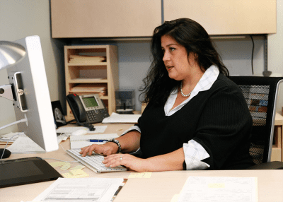 Woman Working at Computer | Obesity Discrimination and Weight Stigma in the Workplace